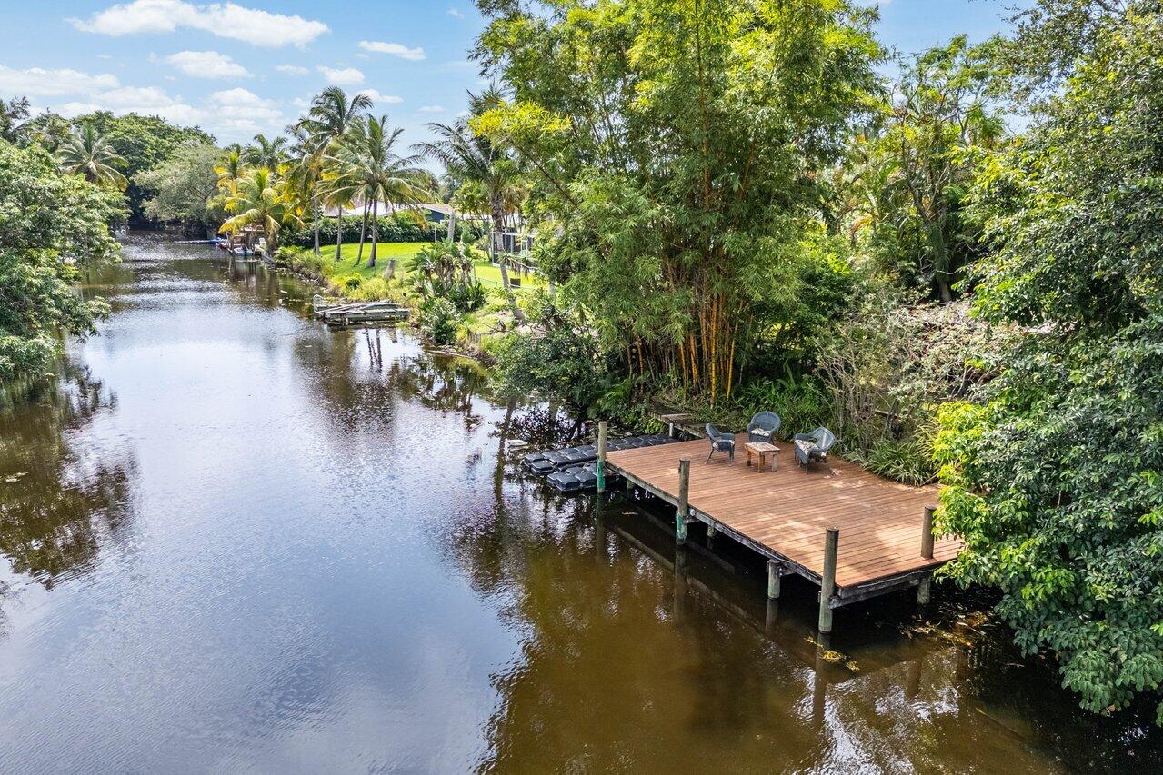 a view of house with yard outdoor seating and lake view