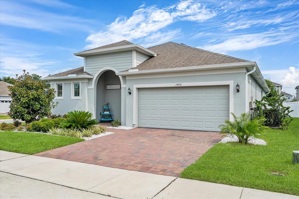 a front view of a house with a yard and garage