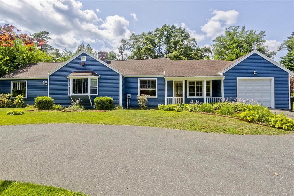 a front view of house with yard and green space