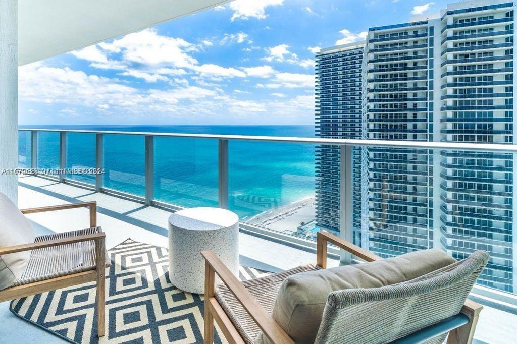 a view of a balcony with couches and wooden floor