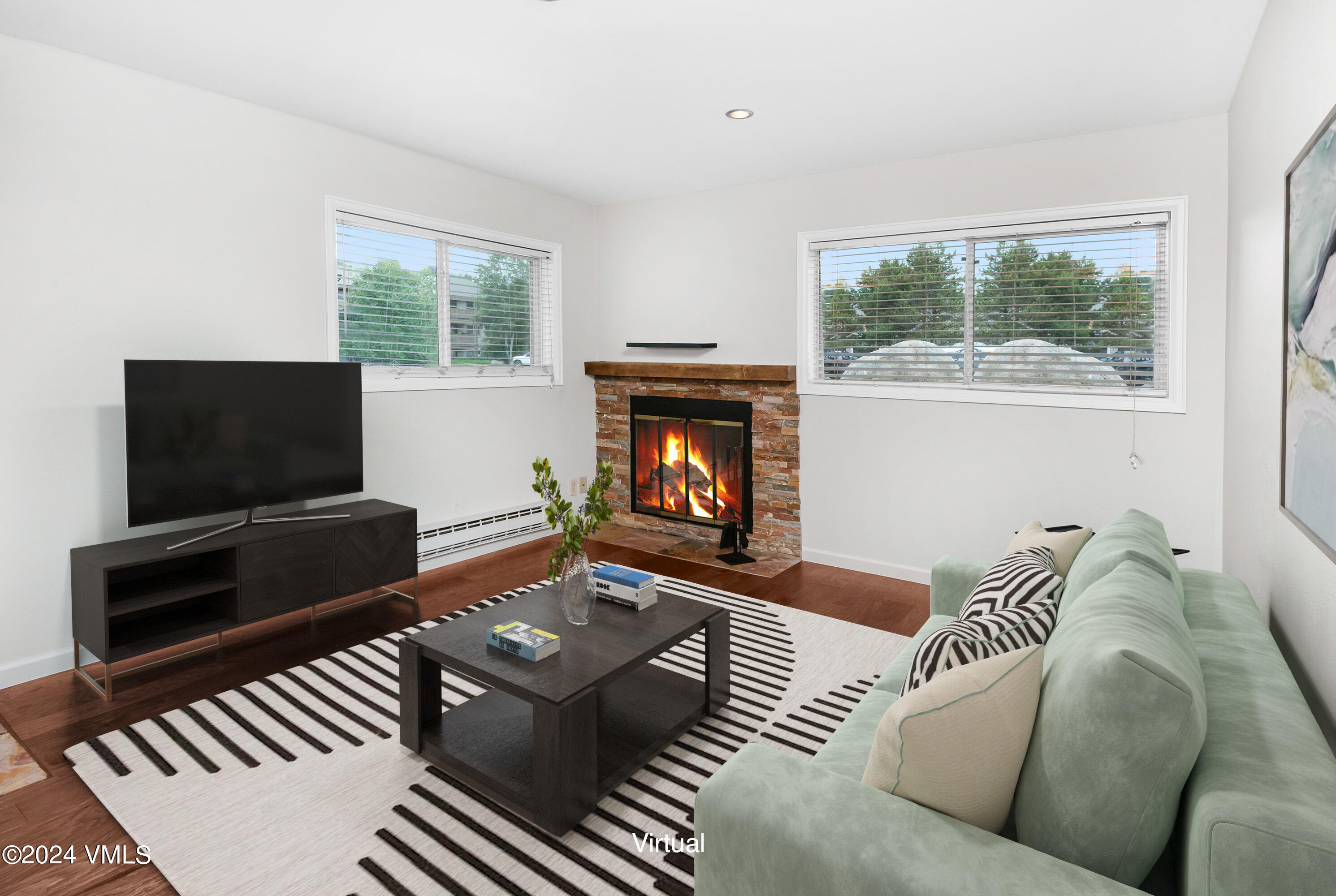 a living room with furniture a flat screen tv and a fireplace