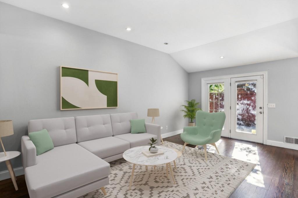 a living room with furniture and a wooden floor