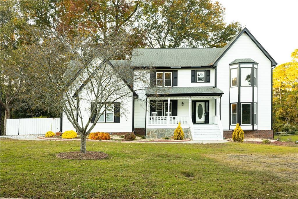 a front view of a house with yard and green space