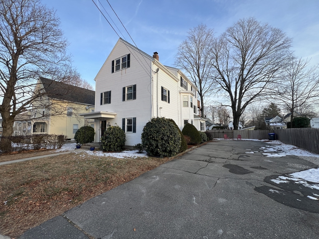 a house that has a tree in front of it