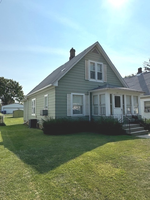 a front view of a house with a garden