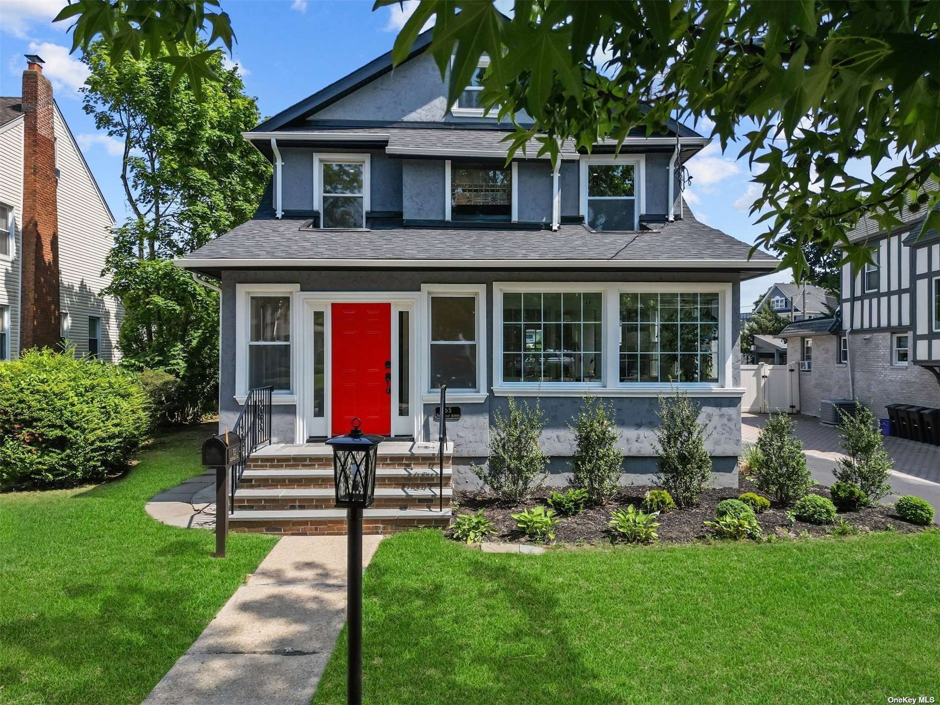 a front view of a house with a yard table and chairs