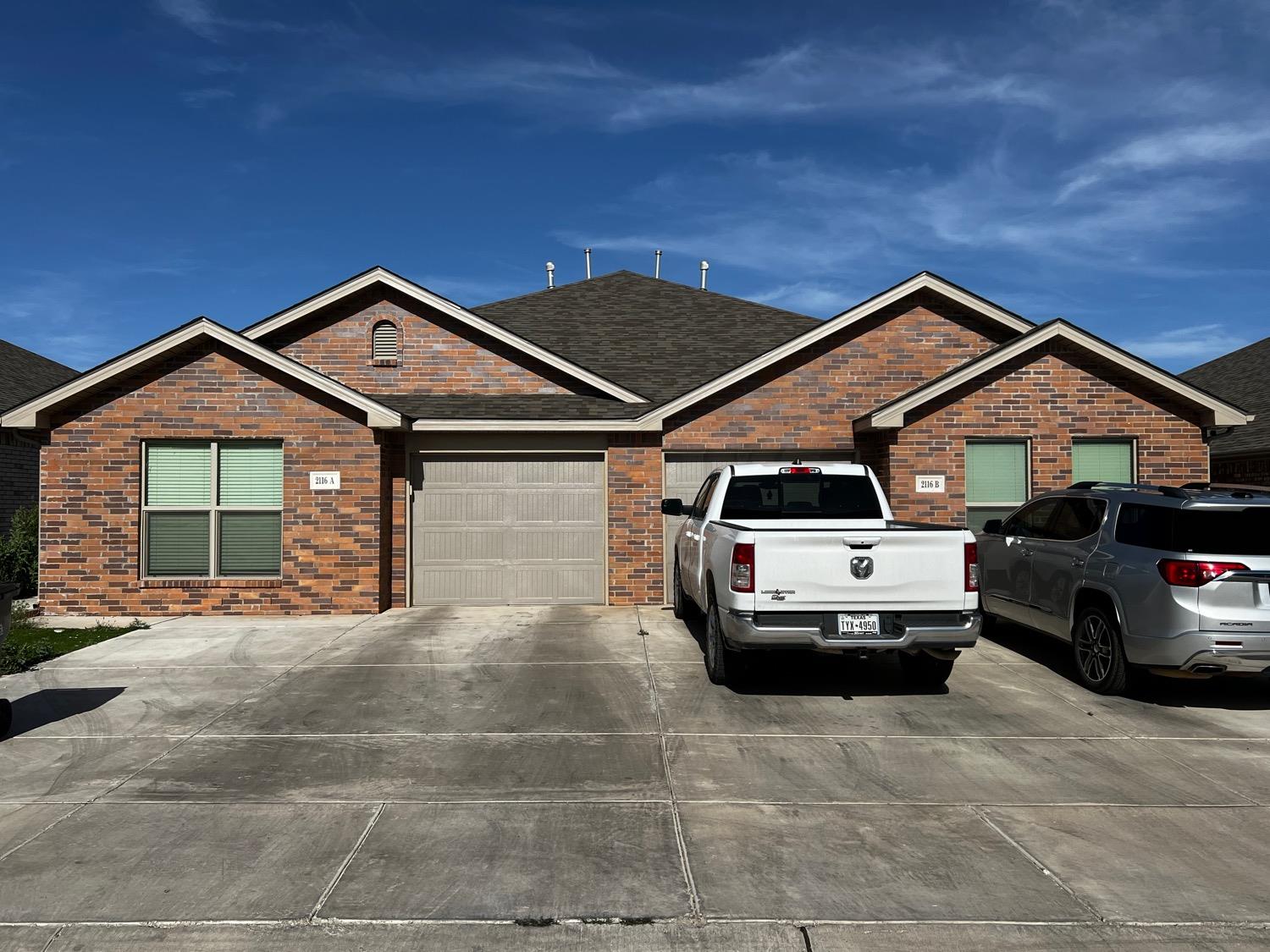 a front view of a house with parking space