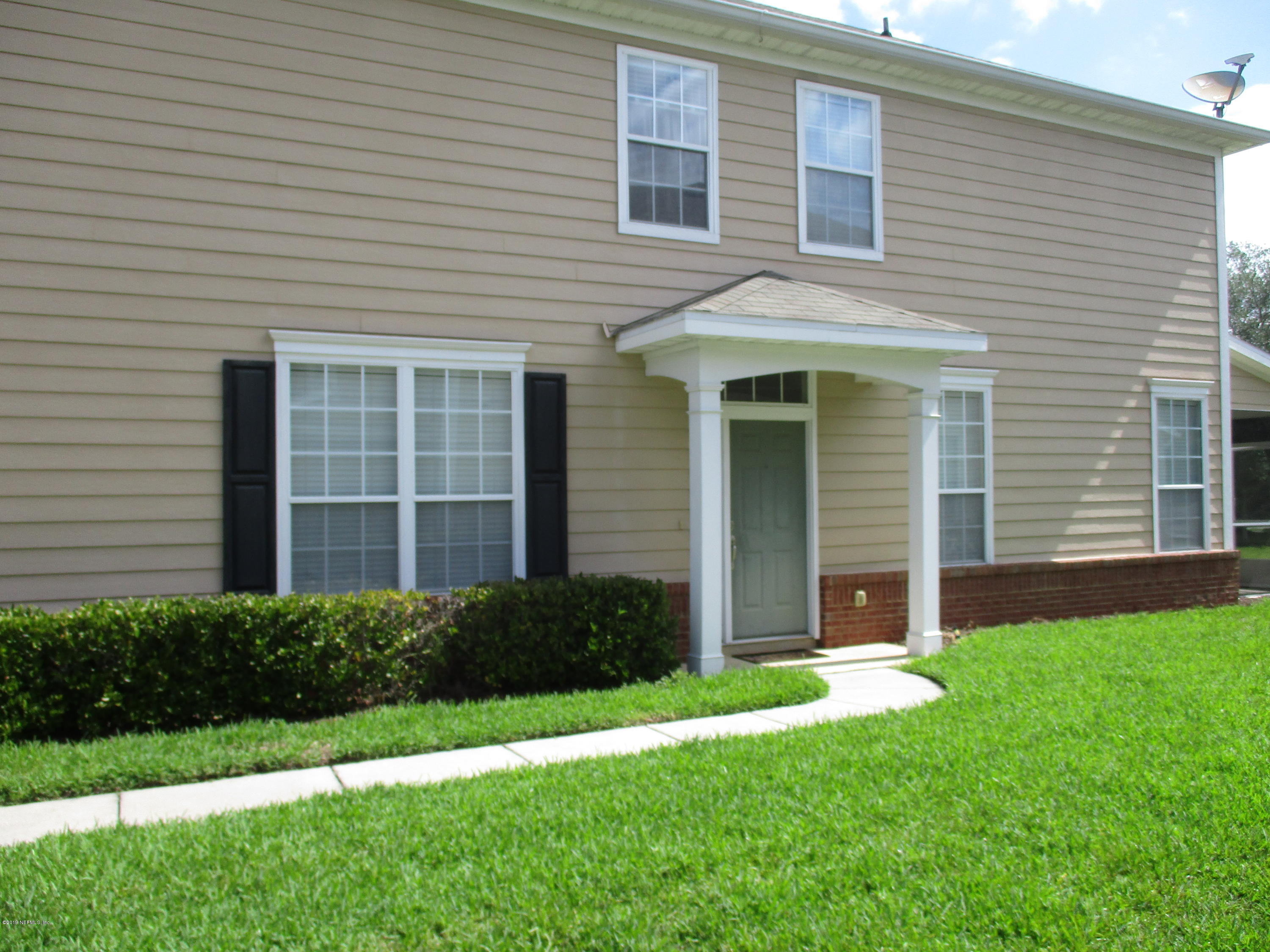 a view of a house with a yard and plants