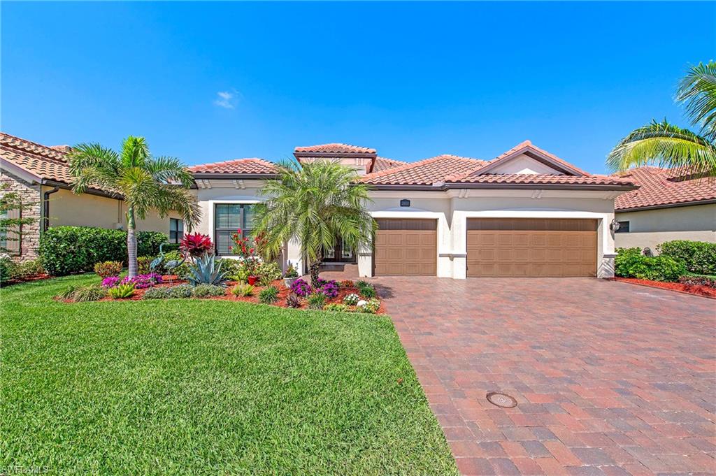 a front view of a house with a yard and potted plants