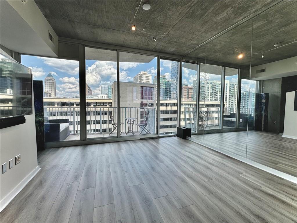 an empty room with wooden floor and walls