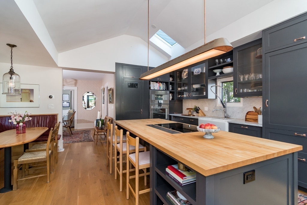 a kitchen with a table chairs and wooden floor