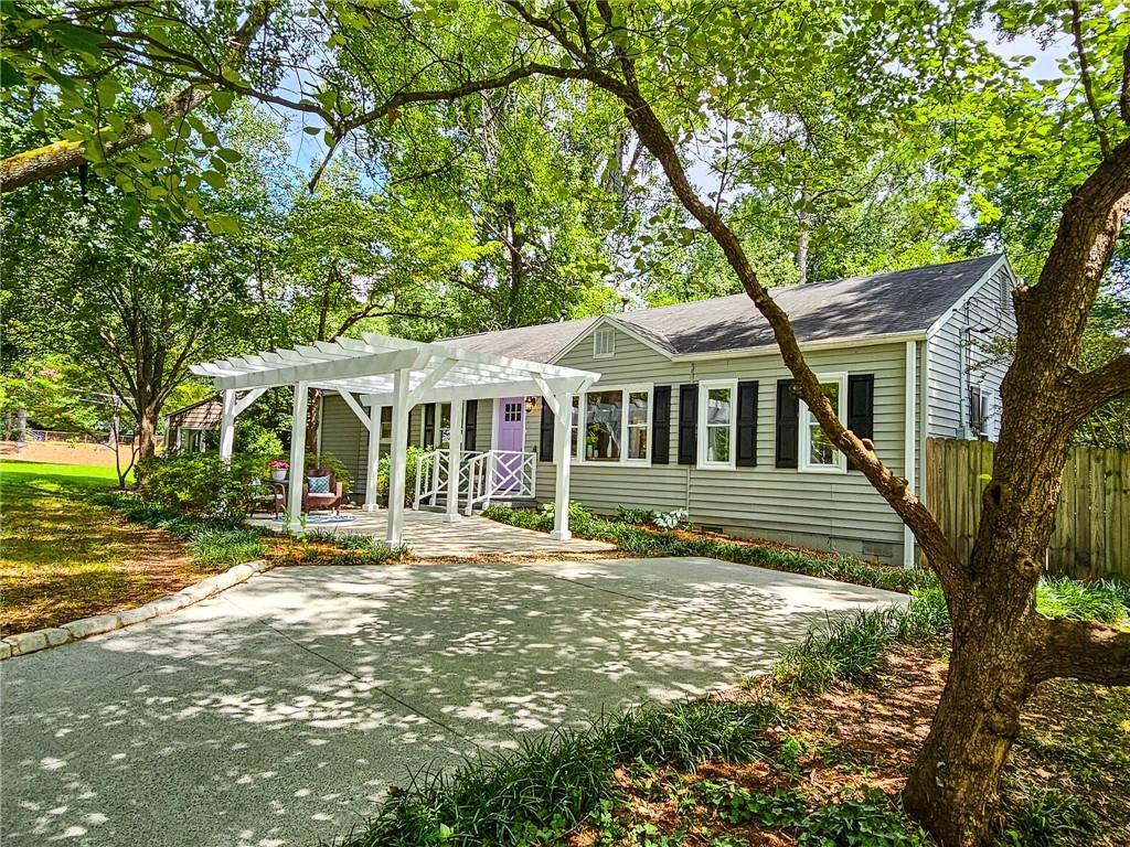 a front view of a house with a garden