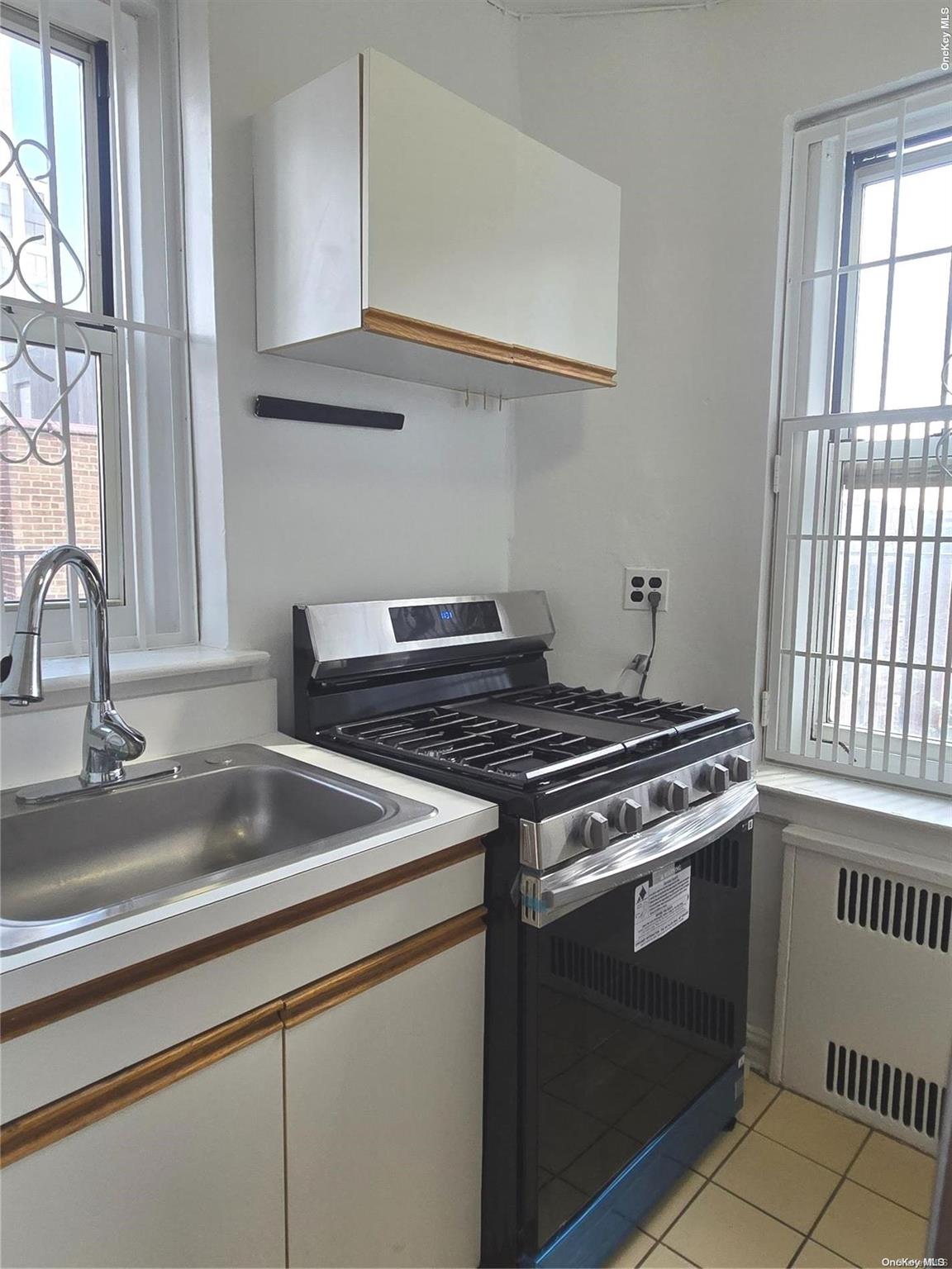 a kitchen with granite countertop a sink stainless steel appliances and cabinets