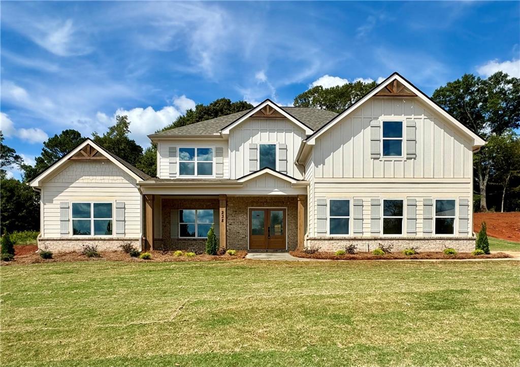 a front view of a house with a garden