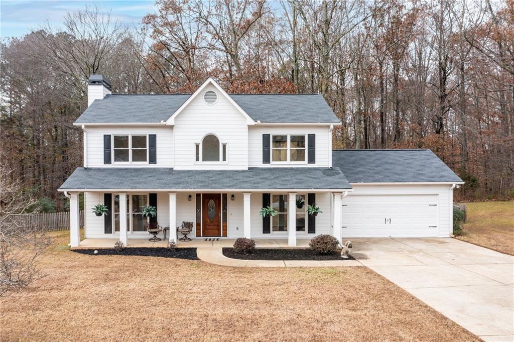 a front view of a house with yard and garage