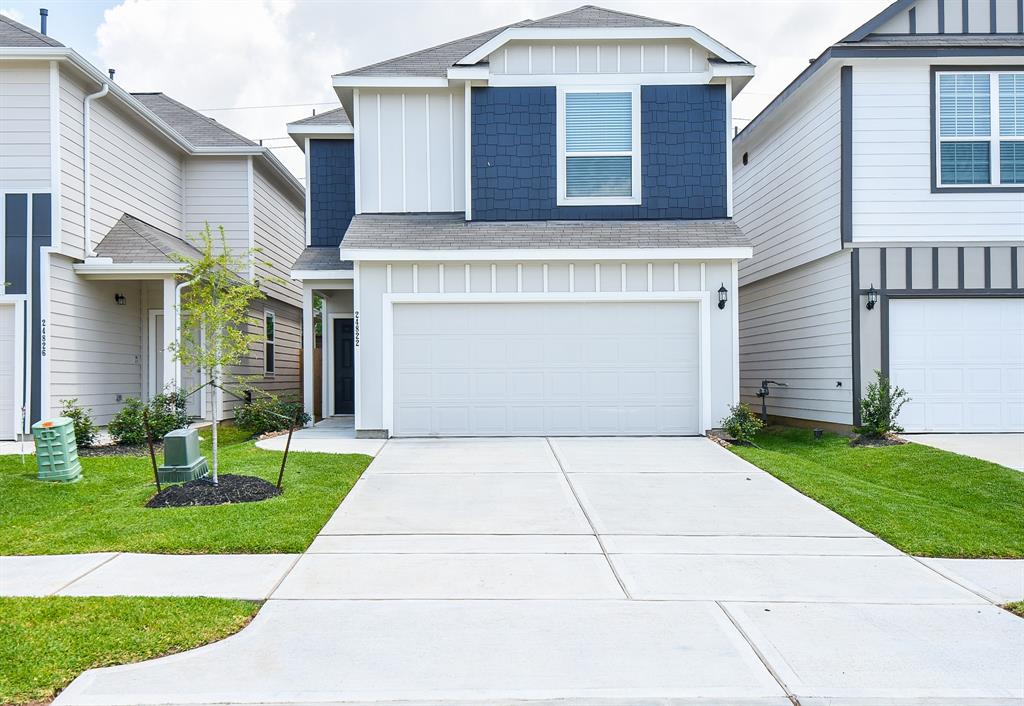 a front view of a house with a yard and garage