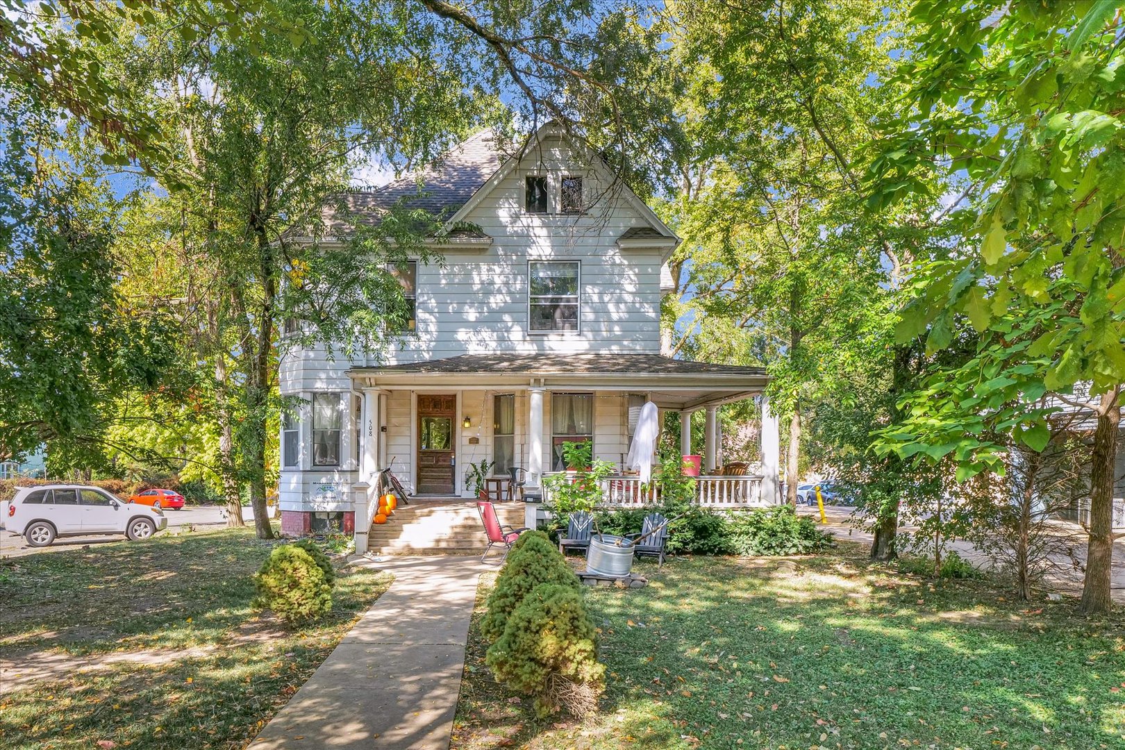 a front view of a house with yard porch and outdoor seating