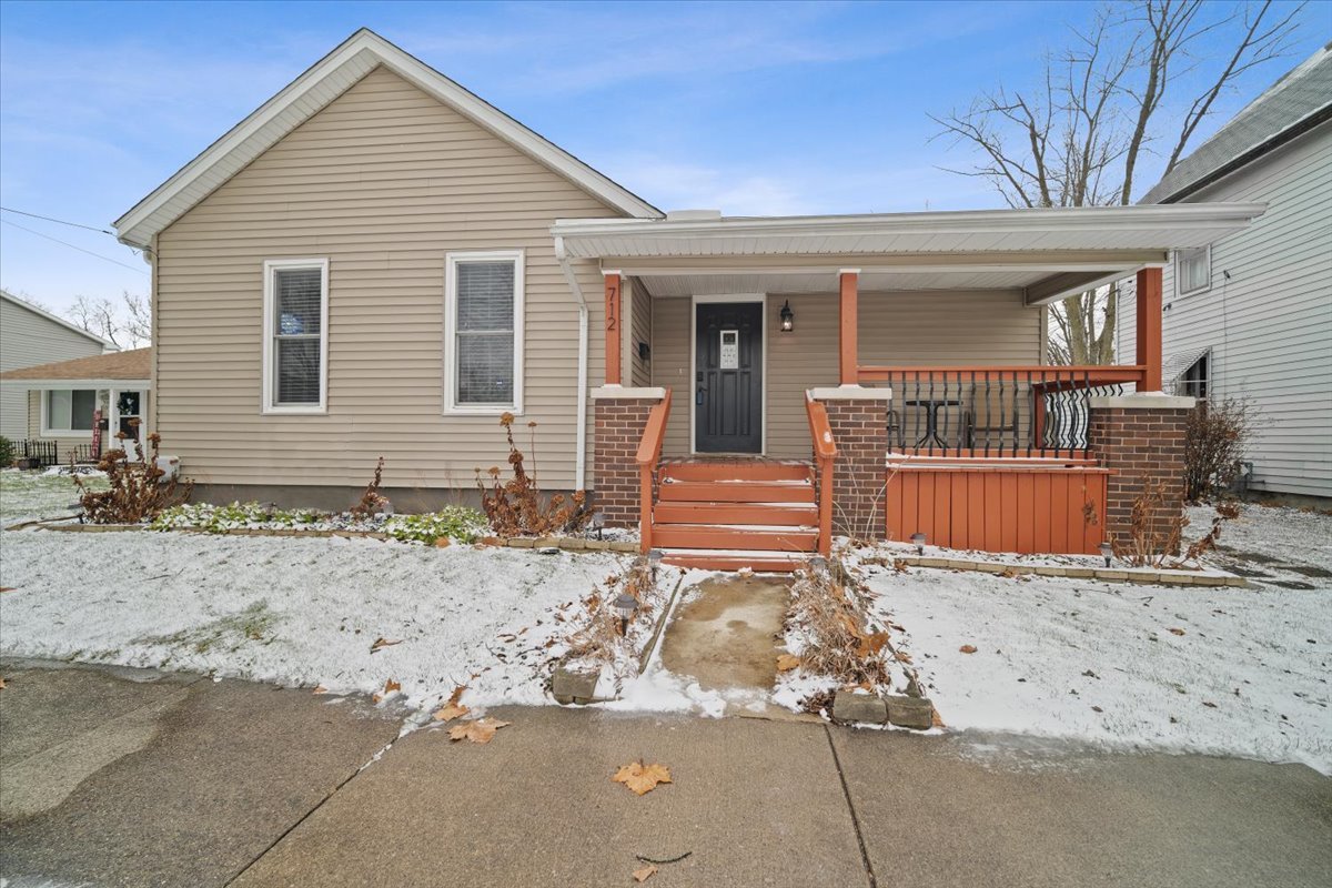 a view of a house with a yard and wooden fence