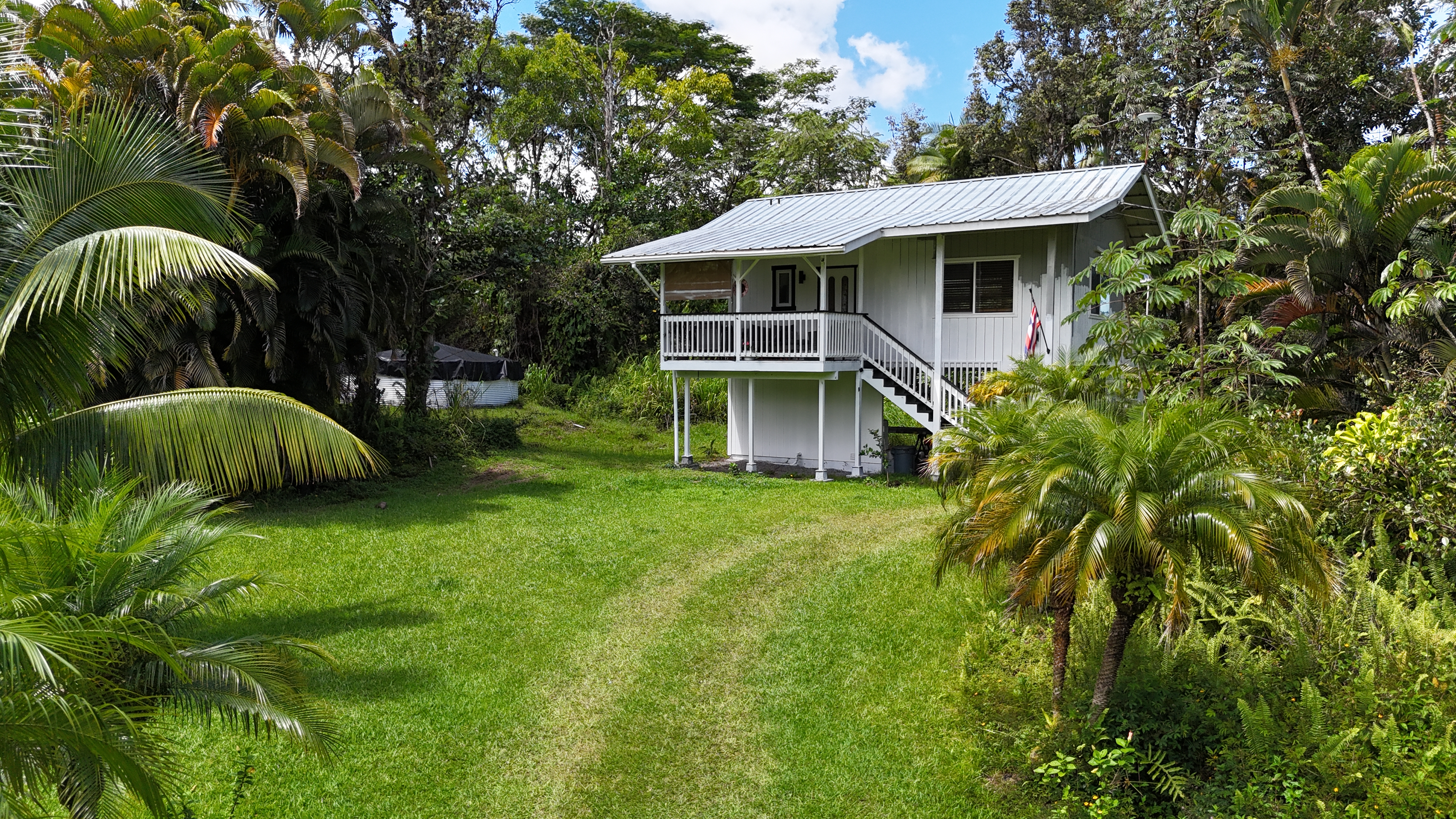 a view of a house with a backyard and sitting area