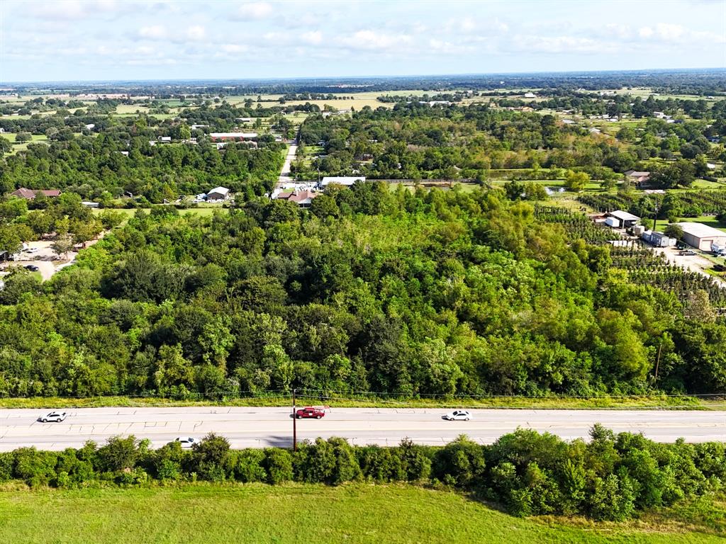 an aerial view of field with trees