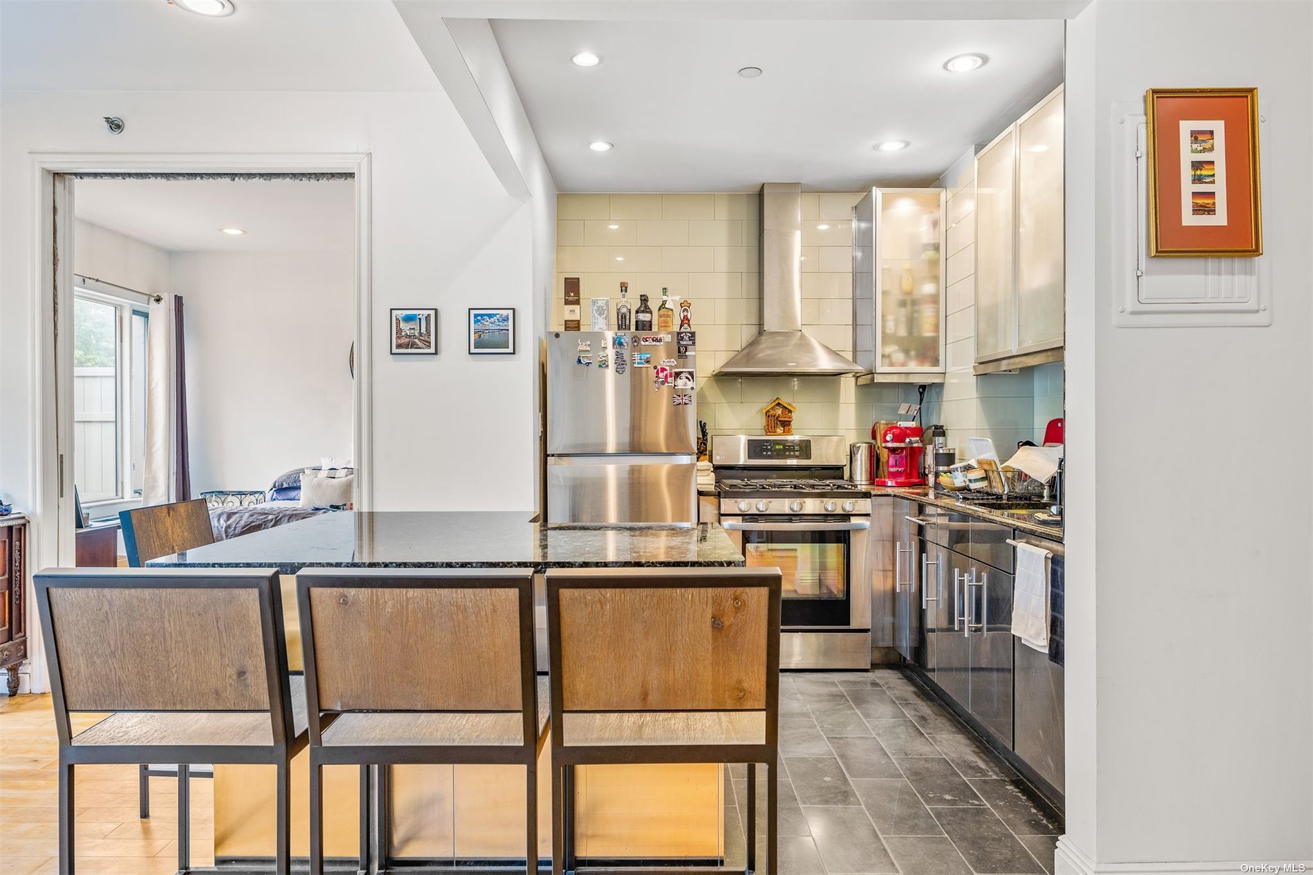 a kitchen with kitchen island granite countertop wooden cabinets and stainless steel appliances