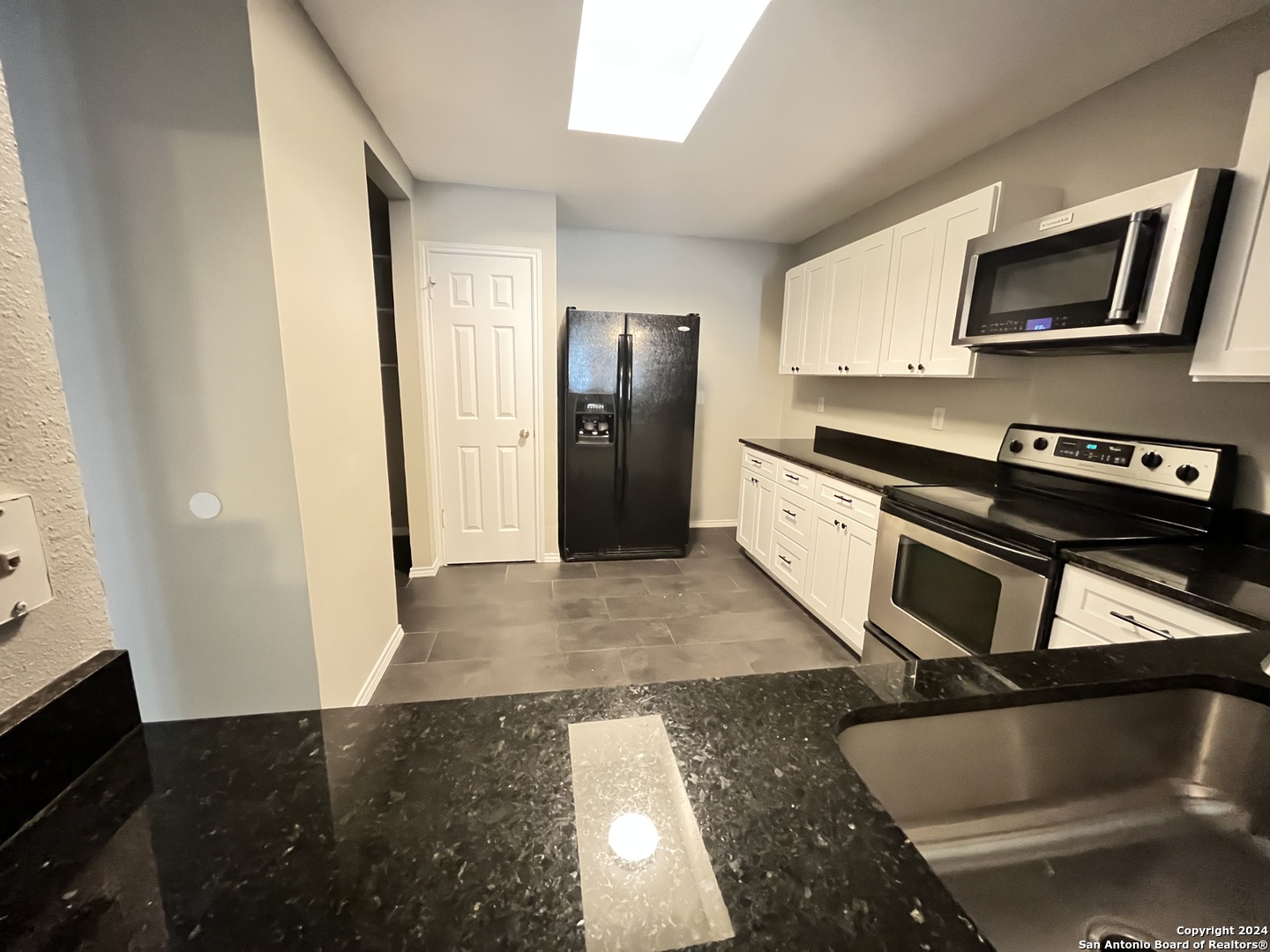 a kitchen with a sink and stainless steel appliances