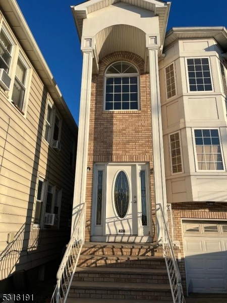 a front view of a house with stairs