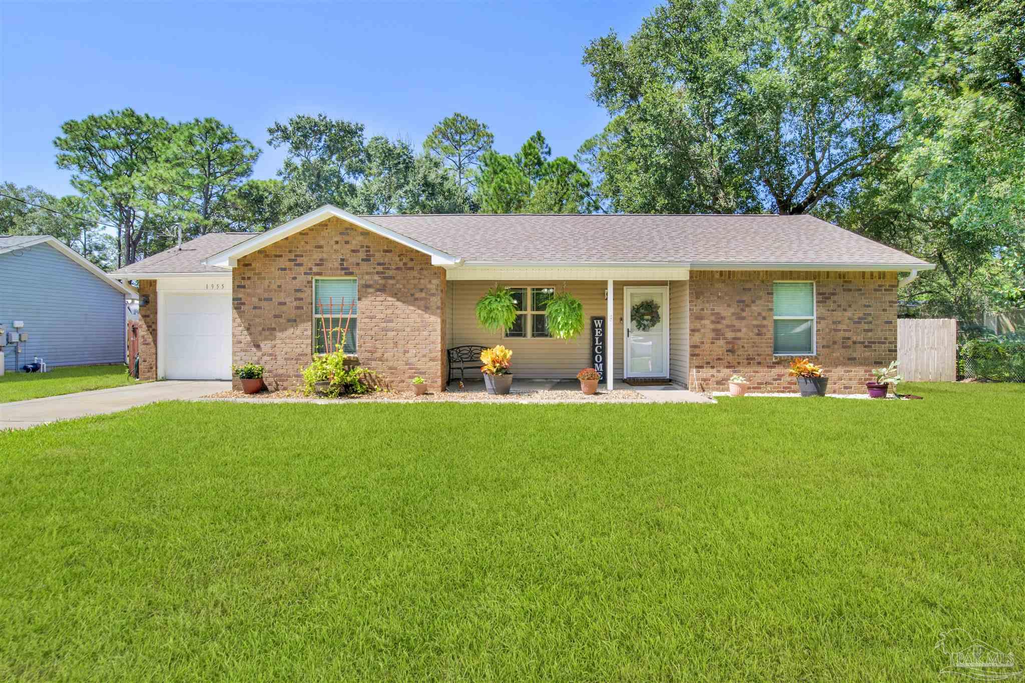 a front view of house with yard and green space