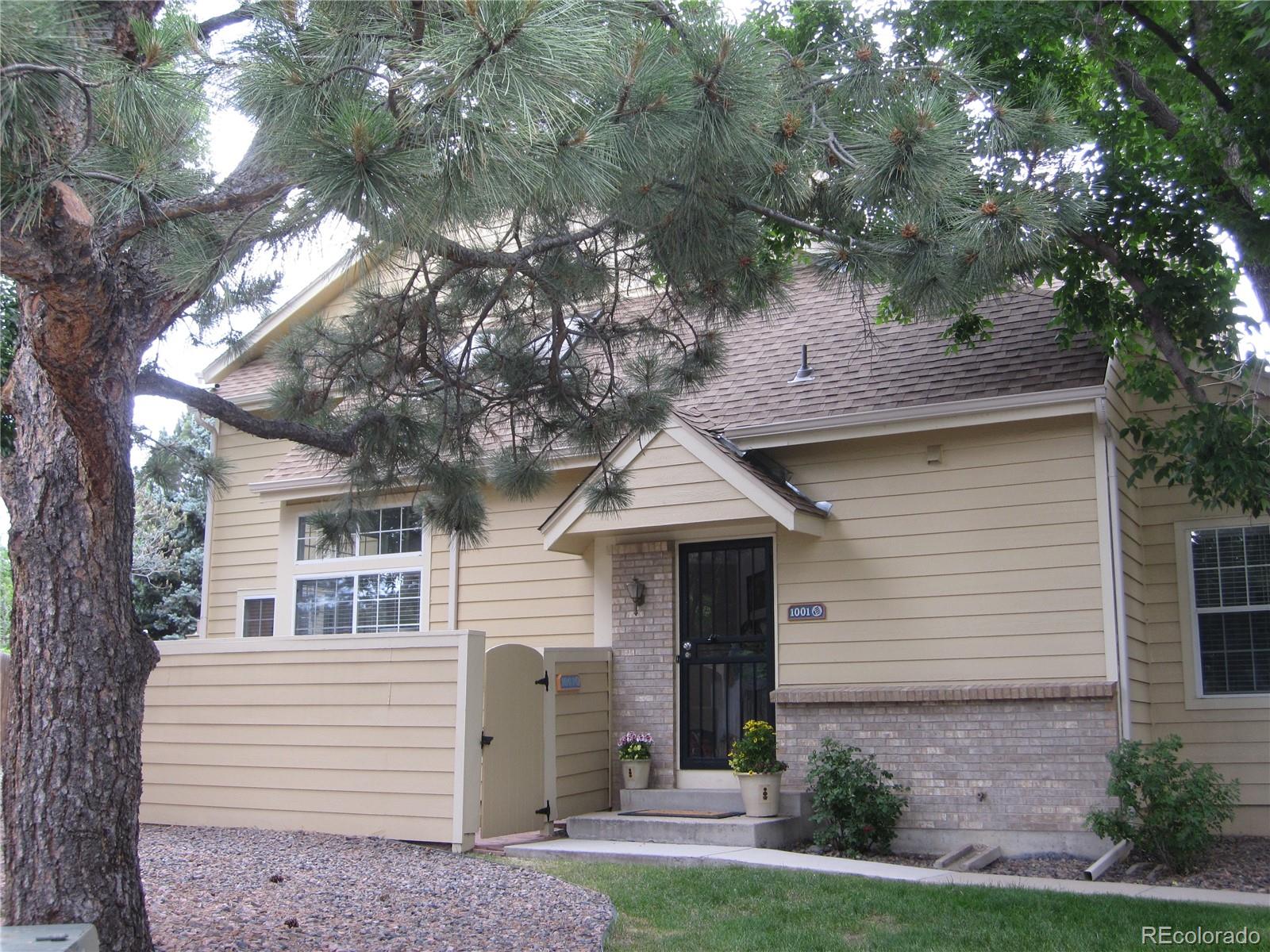 front view of a house with a tree