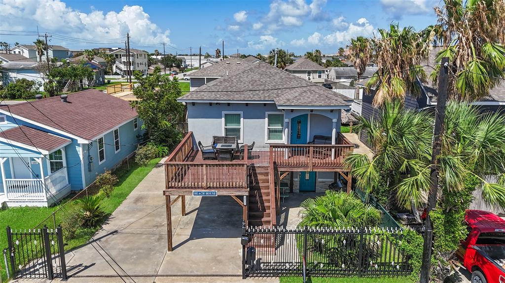 a aerial view of a house with a yard table and chairs