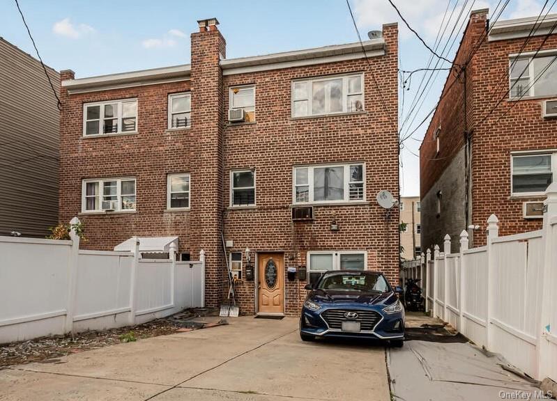 a car parked in front of a brick house