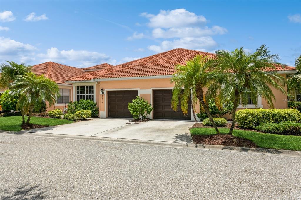 a front view of house with a garden