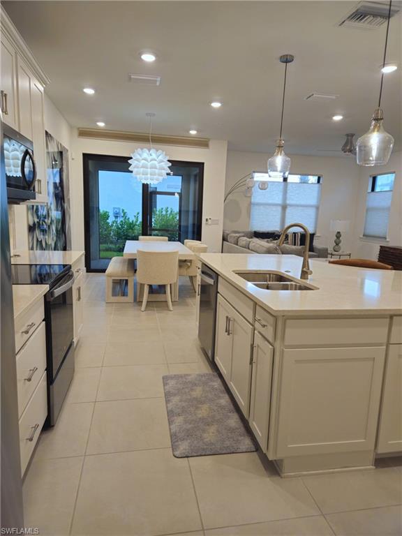 a large white kitchen with a large island oven