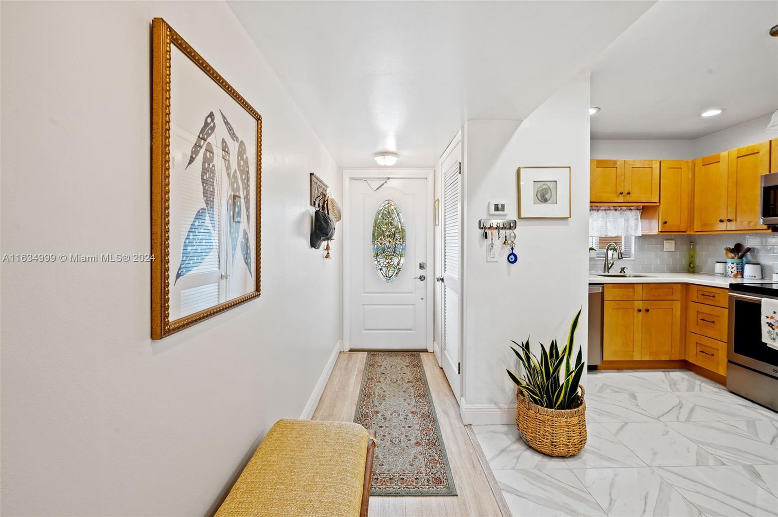 a view of a hallway with dining area and chandelier