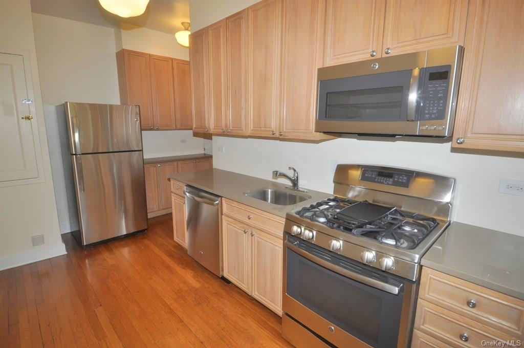 a kitchen with appliances a sink and a stove