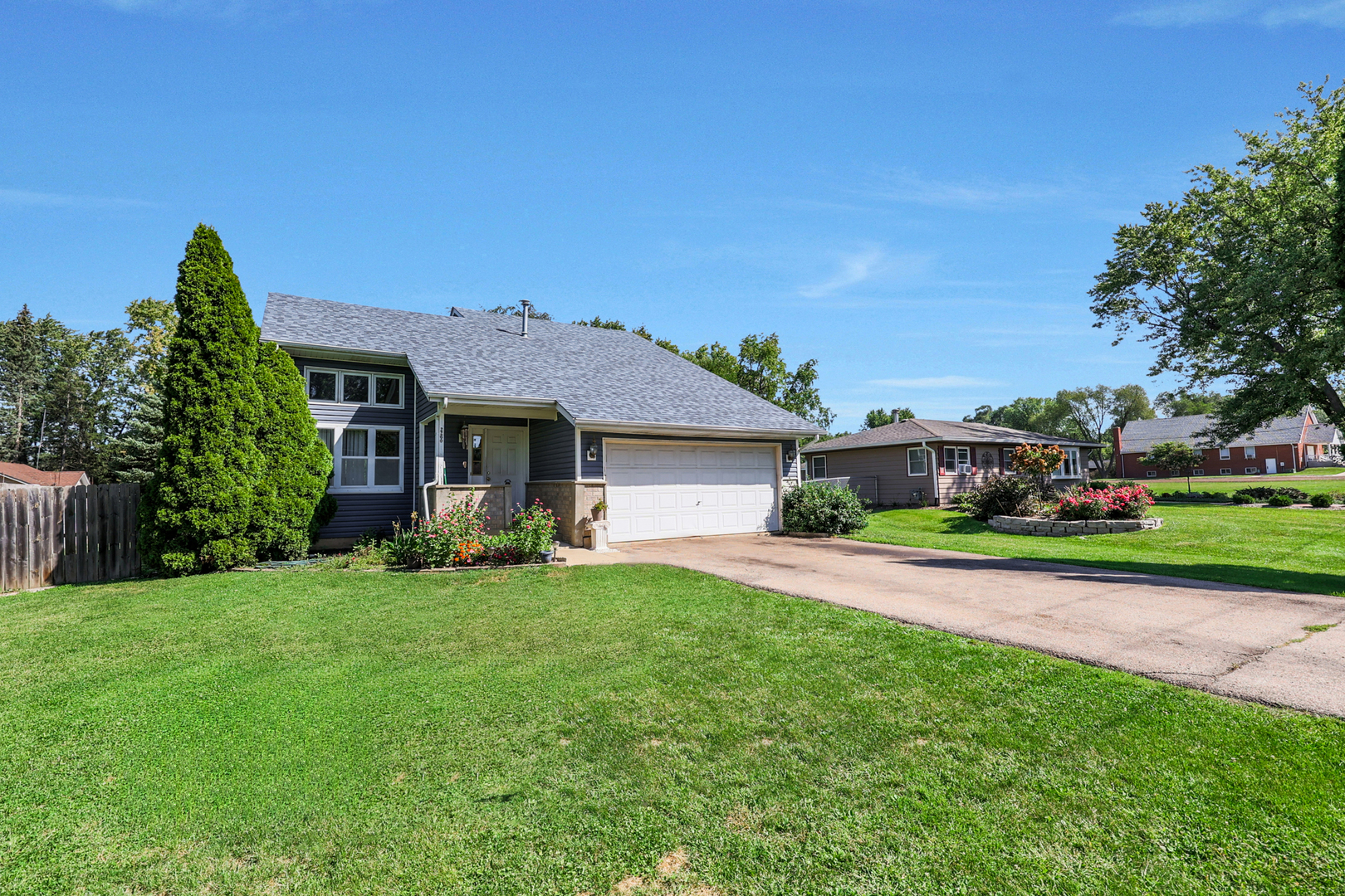 a view of a house with a yard and pathway