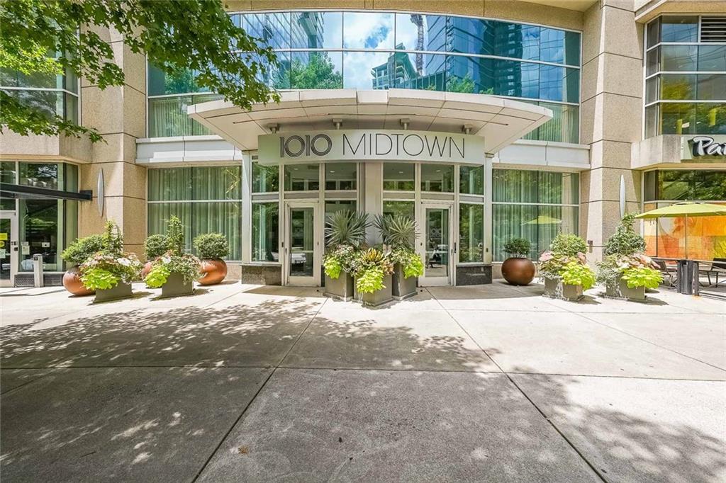 a couple of potted plants in front of building