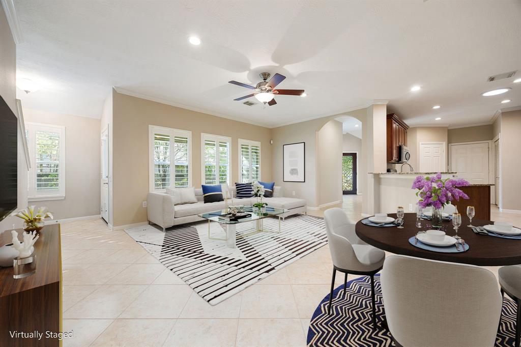 a living room with furniture a flat screen tv and a window