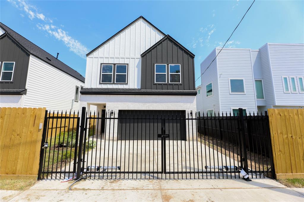 a view of a house with wooden fence