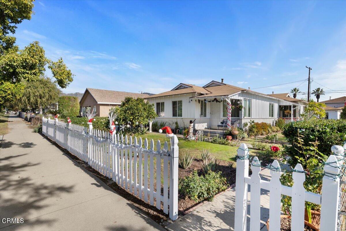 a view of a house with wooden fence