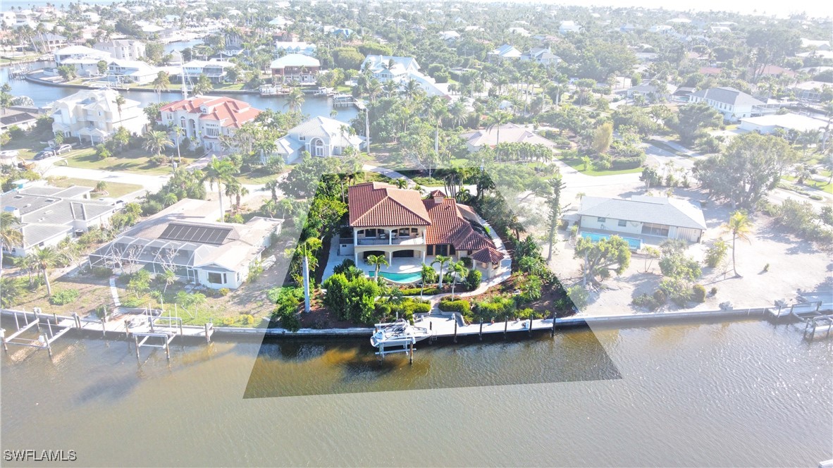 an aerial view of residential houses with outdoor space and swimming pool