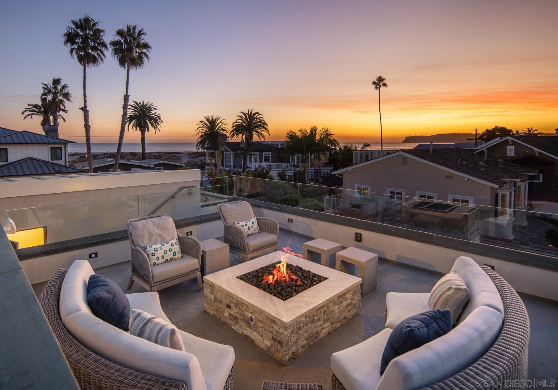 a roof deck with couches and potted plants