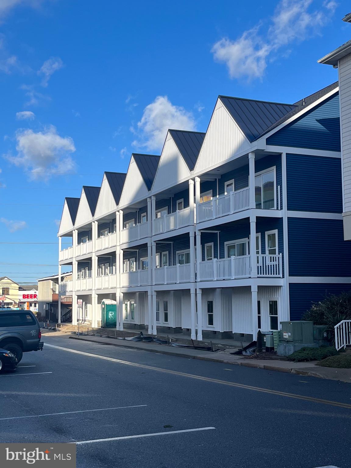 a view of large building next to a road