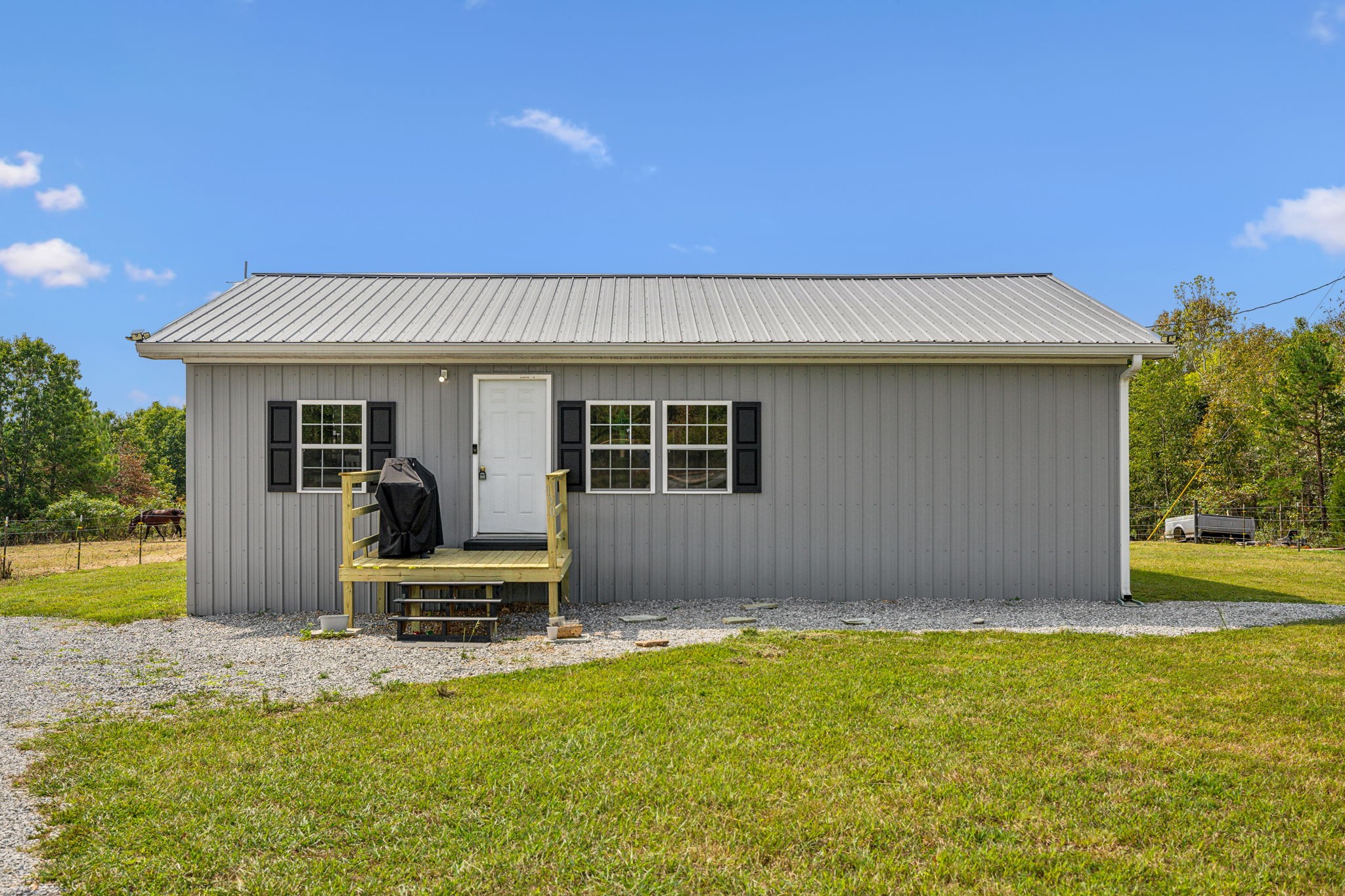 a front view of a house with swimming pool and porch