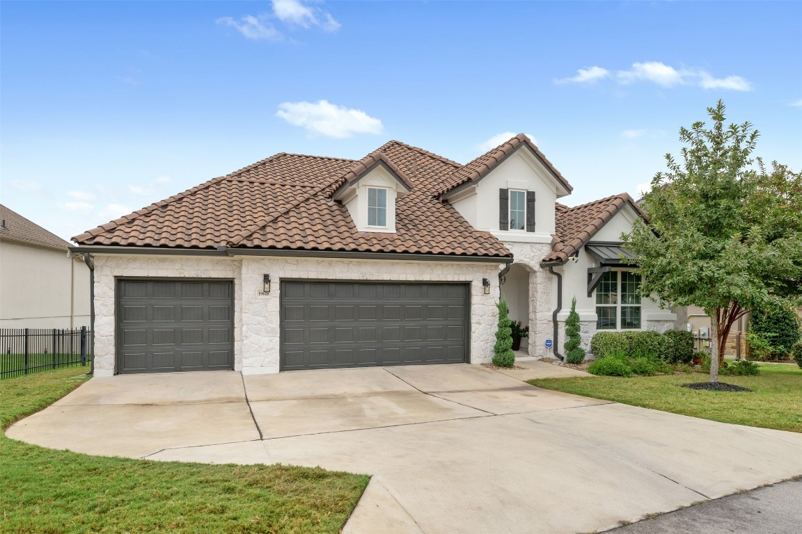 a front view of a house with a yard and garage