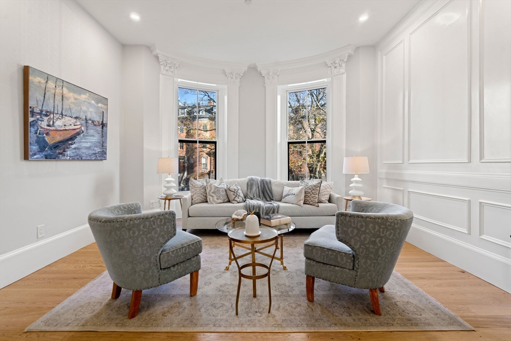 a dining room with furniture a rug and wooden floor