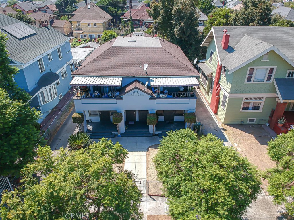 an aerial view of a house with a yard and potted plants