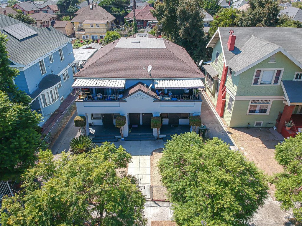 an aerial view of a house with a yard and potted plants