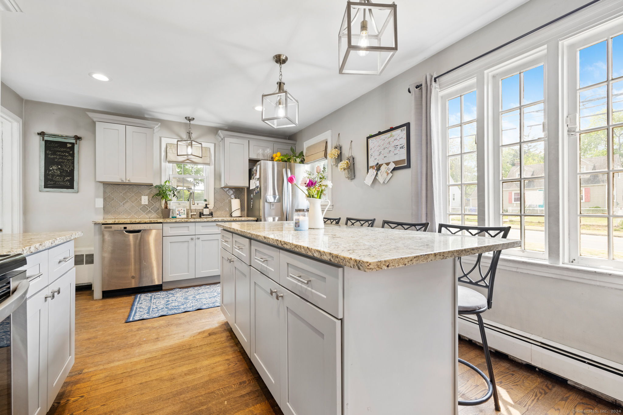 a kitchen with granite countertop a sink appliances cabinets and furniture