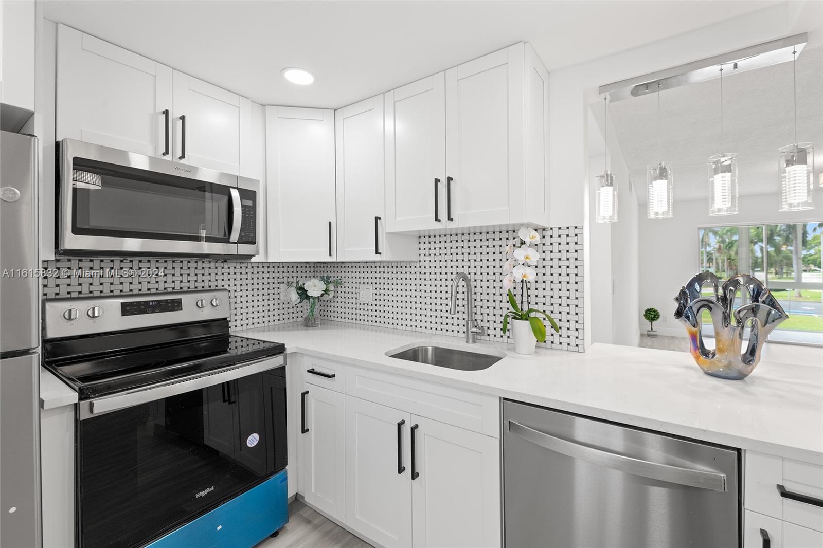 a kitchen with appliances a sink and cabinets